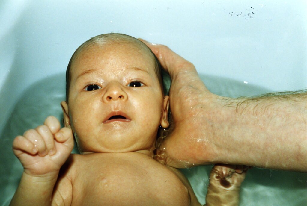 5 weeks old, having a bath.
